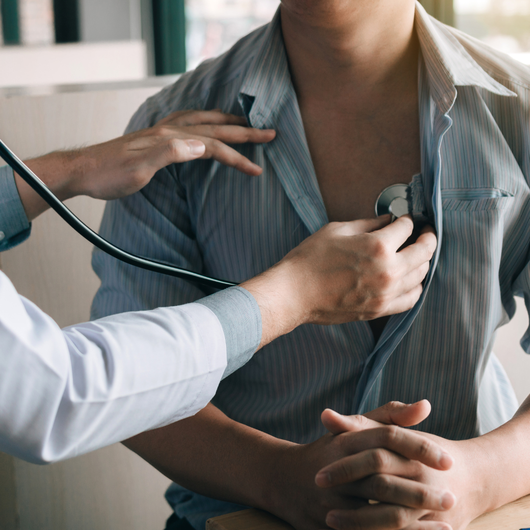 Specialist Cardiologist using a stethoscope on a patient Specialist Cardiologist using a stethoscope on a patient